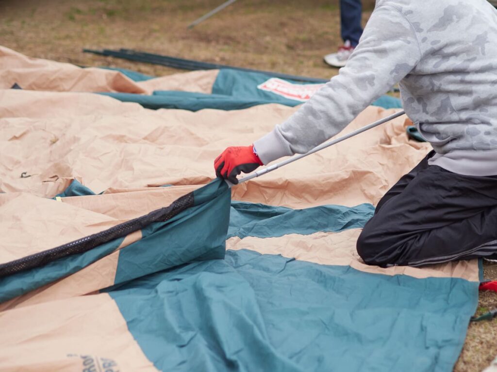 Man disassembling a tent.