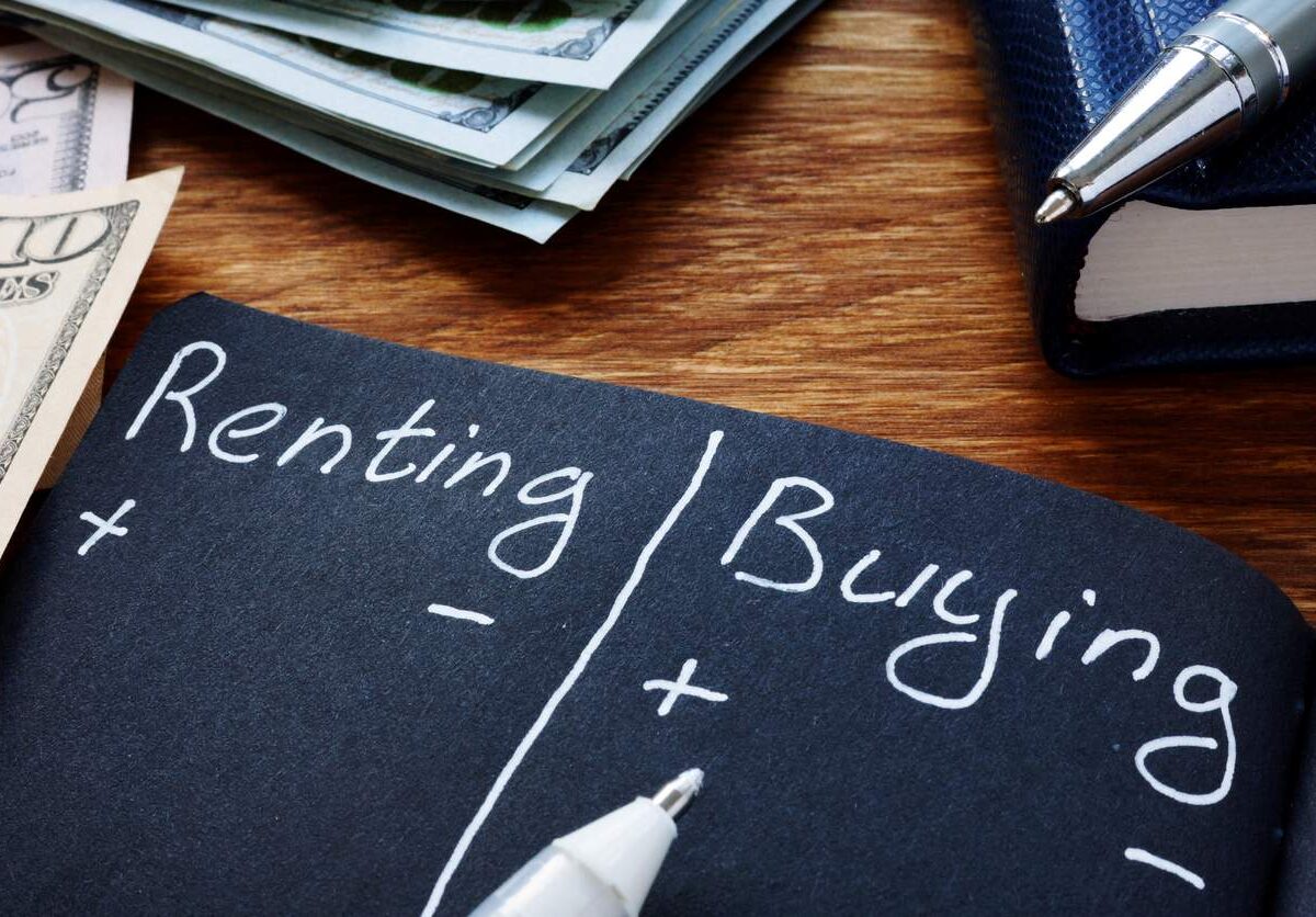 A pros and cons list for renting or buying a home written in white ink on black paper.